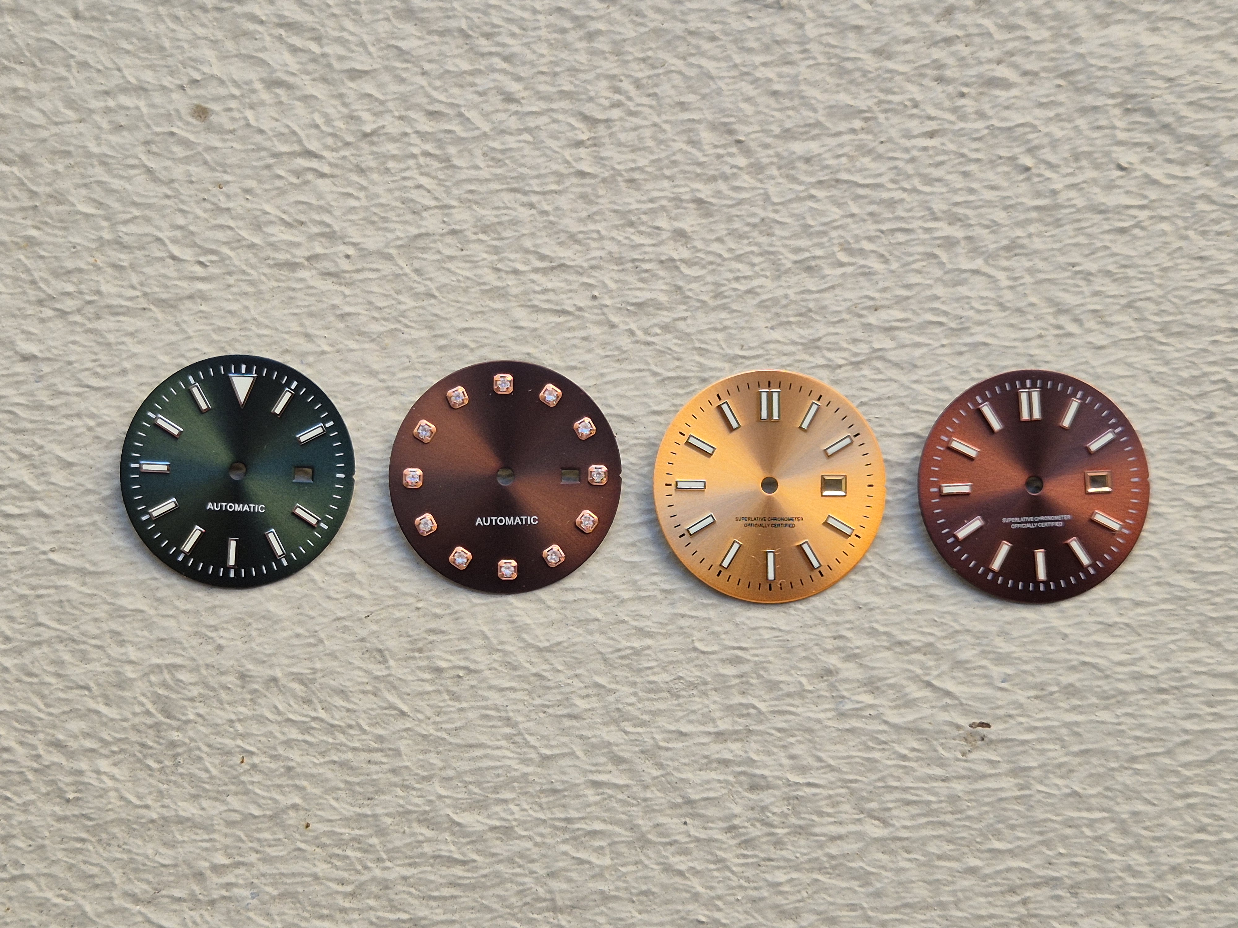 Four NH-series dials side by side showing different date window configurations